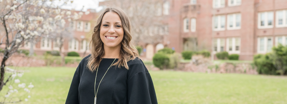 Principal Amanda McDonald in front of the school