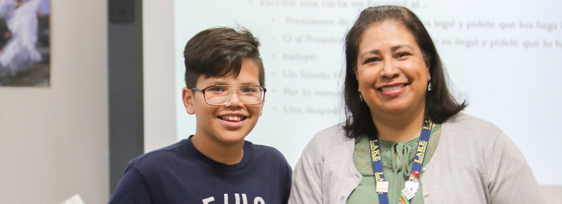 Teacher and student posing in class