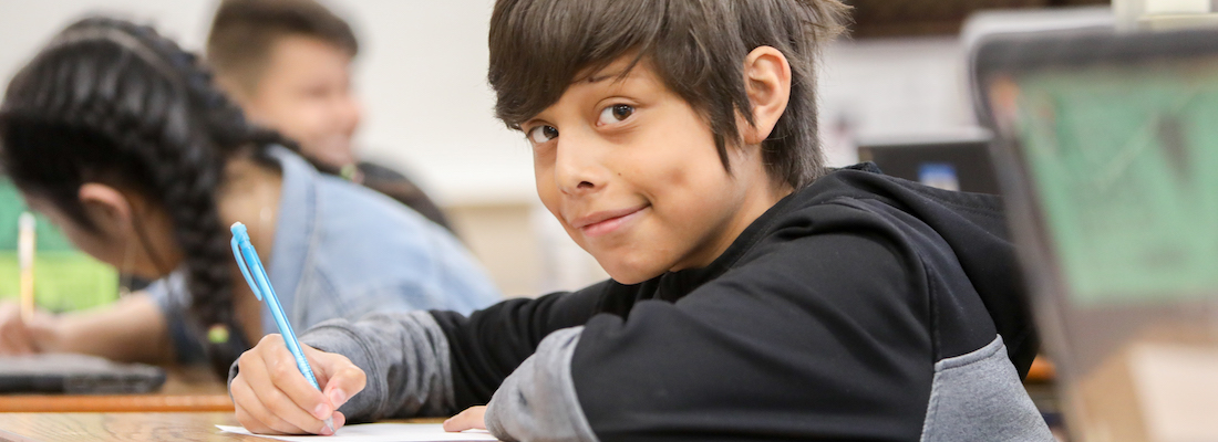 Lake student writing in a classroom